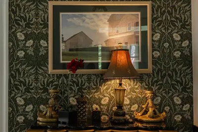 a table with two lamps and a picture on a wall at Historic Home near Stony Brook Village & Beach in Stony Brook
