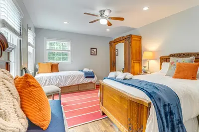 a bedroom with two beds and a ceiling fan at Pool, Sunroom and Gardens Luxe Sandy Hook Home!