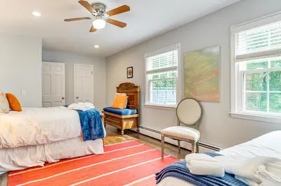 a bedroom with two beds and a ceiling fan at Pool, Sunroom and Gardens Luxe Sandy Hook Home!