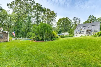 a large yard with a house and a pool at Pool, Sunroom and Gardens Luxe Sandy Hook Home!