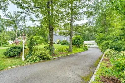 an empty street in a home with trees at Pool, Sunroom and Gardens Luxe Sandy Hook Home!