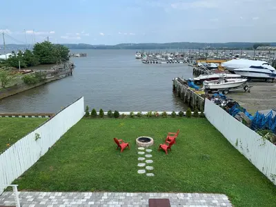 a view of a marina with two red chairs at Waterfront Luxury in Town in Piermont