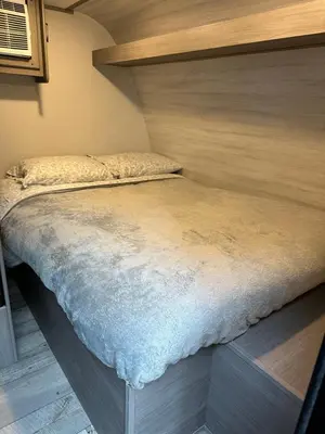 a large bed in a small room with at Cozy Camper Retreat on Sleepy Hollow Lake in Athens