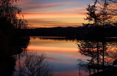 a view of a lake at sunset at Cozy Camper Retreat on Sleepy Hollow Lake in Athens