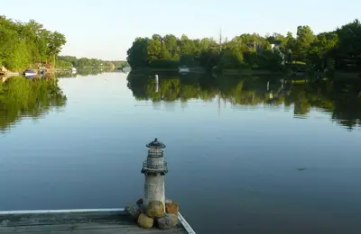 a lighthouse in the middle of a body of water at Cozy Camper Retreat on Sleepy Hollow Lake in Athens