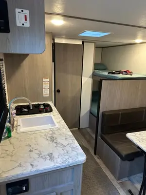 a kitchen with a sink and a counter top at Cozy Camper Retreat on Sleepy Hollow Lake in Athens