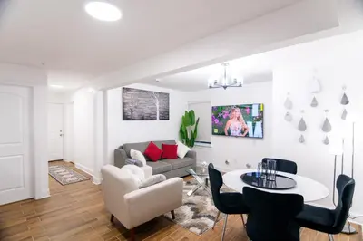 a living room with a couch and a table at BrightOAK Eloire-Private in Newark