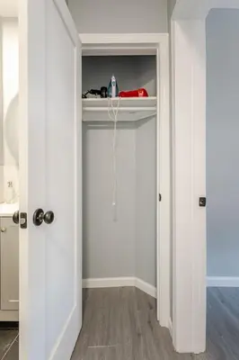 a room with white walls and a white closet at Modern House in Black Rock in Bridgeport