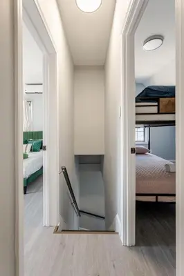 a room with two bunk beds and a hallway at Modern House in Black Rock in Bridgeport