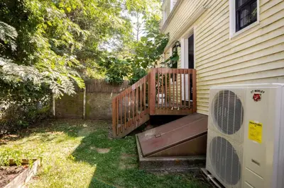 a porch with a deck with a fan next to a house at Modern House in Black Rock in Bridgeport