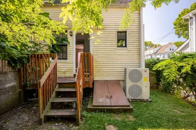 a house with a staircase leading up to a house at Modern House in Black Rock in Bridgeport