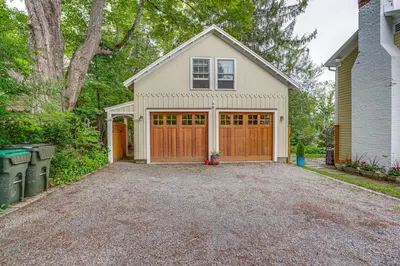 a house with a garage with a driveway at Steps to Downtown Stockbridge Home with Patio! in Stockbridge