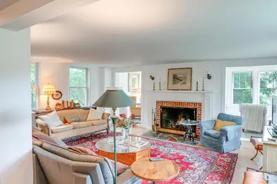 a living room filled with furniture and a fireplace at Steps to Downtown Stockbridge Home with Patio! in Stockbridge