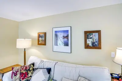 a living room with a couch and pictures on the wall at 2 Mi to Norman Rockwell Museum Stockbridge Apt! in Stockbridge