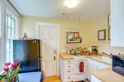 a kitchen with a refrigerator and a stove top oven at 2 Mi to Norman Rockwell Museum Stockbridge Apt! in Stockbridge