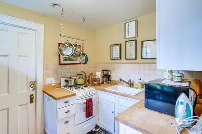 a kitchen with a white stove and a sink at 2 Mi to Norman Rockwell Museum Stockbridge Apt! in Stockbridge