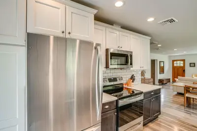 a kitchen with white cabinets and a stainless steel refrigerator at Family Home with Outdoor Oasis in Hudson Valley in High Falls