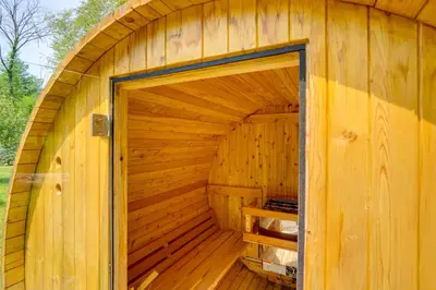 an inside of a wooden sauna with a door at Family Home with Outdoor Oasis in Hudson Valley in High Falls