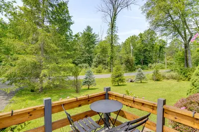 a patio with chairs and a table on a wooden deck at Family Home with Outdoor Oasis in Hudson Valley in High Falls