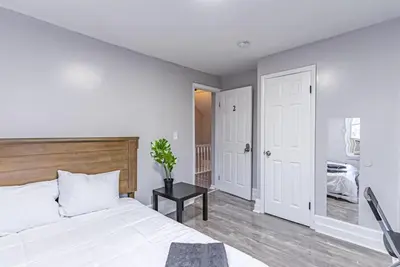 a bedroom with a large white bed and a table at 6Br 2bth NYC Penn Station NYC USA Mall EWR in Newark