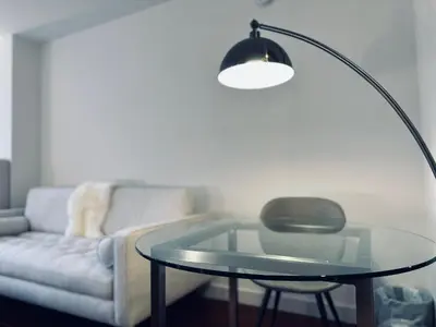 a living room with a glass table and a couch at Entire luxury apt midtown with pool, gym, and sauna in New York