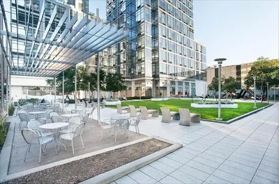a courtyard with tables and chairs in a building at Entire luxury apt midtown with pool, gym, and sauna in New York