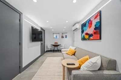 a living room with a couch and a table at luxury 2 bed 2 bath apt with free parking in Jersey City