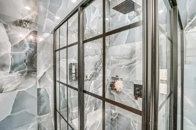 a shower with a glass door in a bathroom at Steps to Union College Home with Shared Yard! in Schenectady