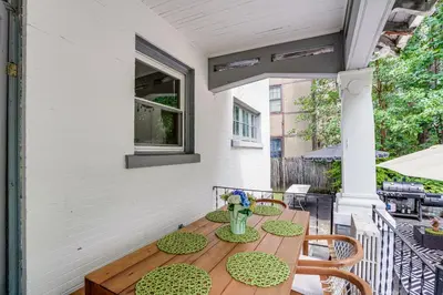 a patio with a table and chairs on a porch at Steps to Union College Home with Shared Yard! in Schenectady