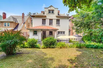 an old house with an orange roof in a yard at Steps to Union College Home with Shared Yard! in Schenectady