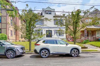two cars parked in a parking lot in front of a house at Walk to Nott Memorial Studious Retreat Near Eats in Schenectady