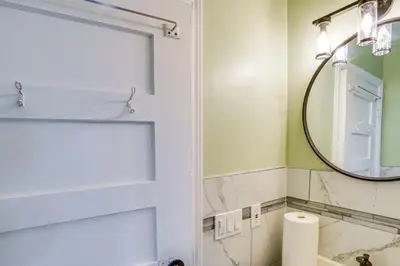 a bathroom with a white door and a mirror at Walk to Nott Memorial Studious Retreat Near Eats in Schenectady