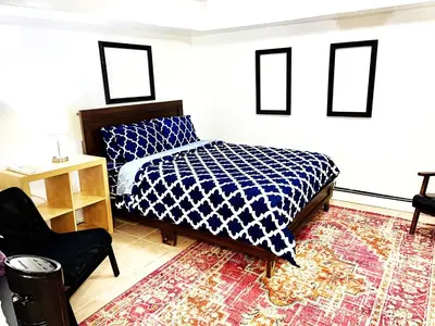a bedroom with a bed and a chair at 2 Bedroom Apt in LIC, Private WITH BACKYARD ! in Roosevelt Island