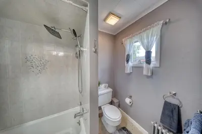 a bathroom with a shower and a toilet and a sink at Charming 2-Bedroom, 1-Bath Getaway in Carbondale