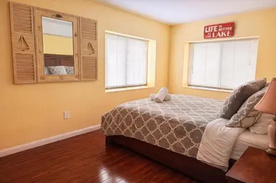 a bedroom with a bed and a mirror at Switch to hosting Peaceful Lakefront Stay, HotTub, Fireplace, Kayaks in East Stroudsburg