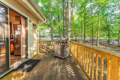 a front porch of a house with a grill at Switch to hosting Peaceful Lakefront Stay, HotTub, Fireplace, Kayaks in East Stroudsburg