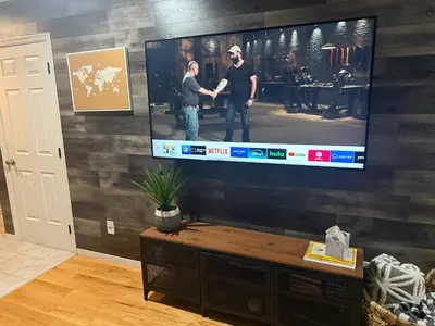 a living room with a flat screen tv on a wall at Mountain Modern Escape - EV Charger - 5BDRM in Hensonville