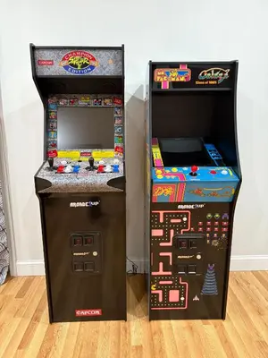two arcade machines next to each other on a floor at Mountain Modern Escape - EV Charger - 5BDRM in Hensonville