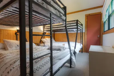 a couple of bunk beds in a room at MtSnow , HotTub, Pool, Air Hockey,Ping Pong, Darts in Wilmington