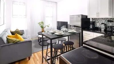 a kitchen with a table with glasses on it at Spacious 3BR Retreat Near Times Square in New York