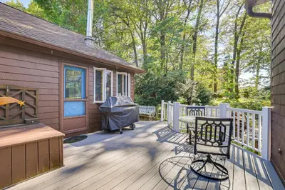 a wooden deck with a grill and a house at Family Getaway in Bristol Near Trails and Parks! in Bristol