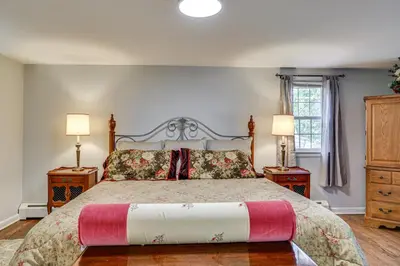 a bedroom with a bed with two night stands and two lamps at Family Getaway in Bristol Near Trails and Parks! in Bristol