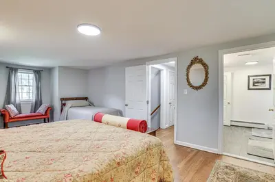a bedroom with two beds and a mirror at Family Getaway in Bristol Near Trails and Parks! in Bristol