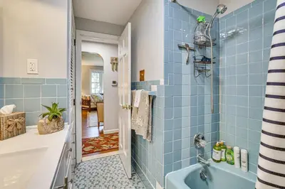 a blue bathroom with a tub and a sink at Family Getaway in Bristol Near Trails and Parks! in Bristol
