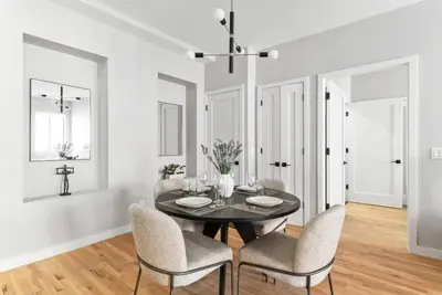 a dining room with a black table and chairs at Top Notch 2BR & 2BA Suite Minutes to Central Park in New York