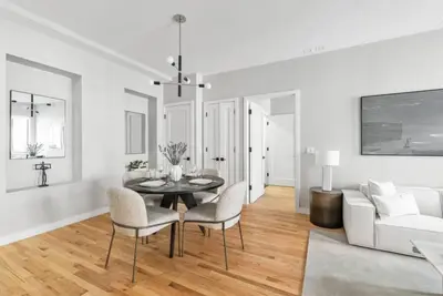 a white living room with a table and chairs at Top Notch 2BR & 2BA Suite Minutes to Central Park in New York