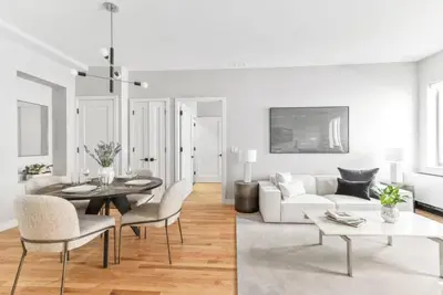 a living room with a white couch and a table at Top Notch 2BR & 2BA Suite Minutes to Central Park in New York
