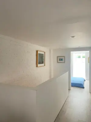 a white room with a bed and a window at Williamsburg Design Apartment in Brooklyn