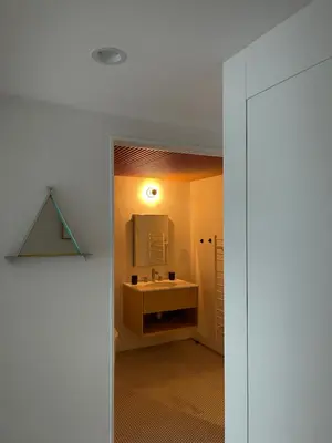 a bathroom with a sink and a mirror at Williamsburg Design Apartment in Brooklyn