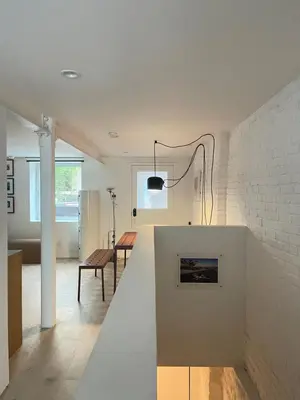 a living room with a white brick wall at Williamsburg Design Apartment in Brooklyn